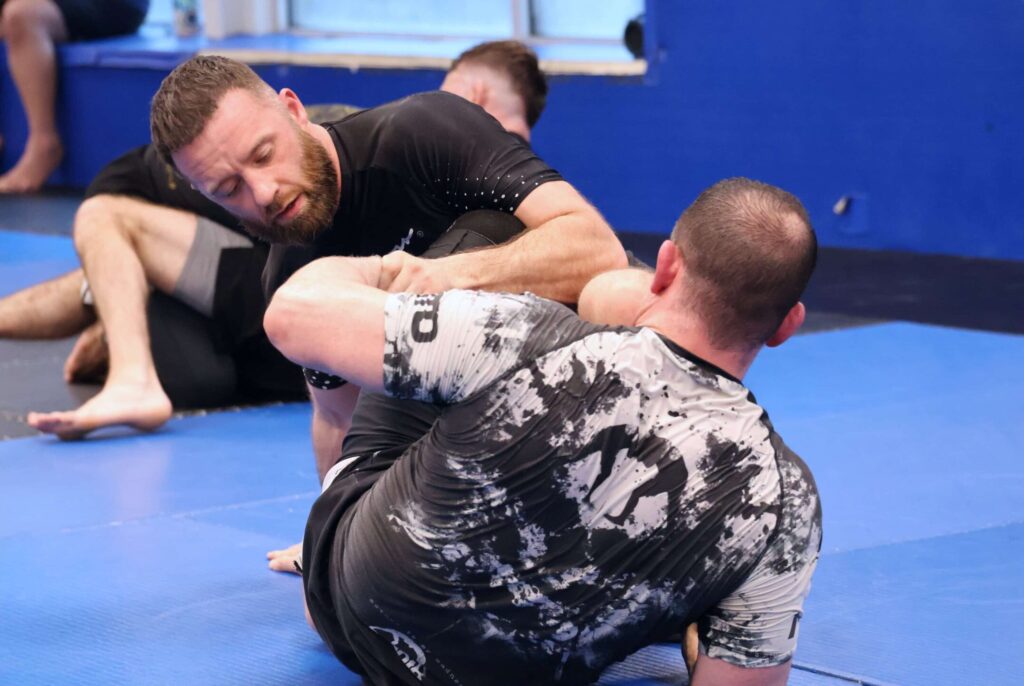 Students at Renzo Gracie Latham doing Brazilian Jiu-Jitsu in No-Gi attire