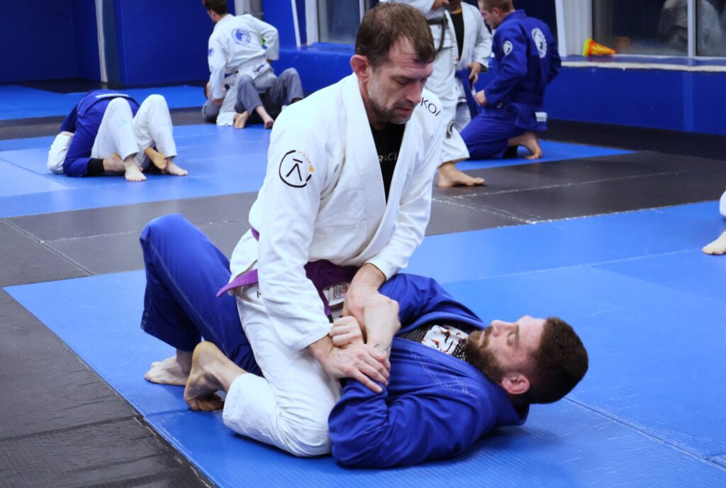 Students at Renzo Gracie Latham doing Brazilian Jiu-Jitsu in a BJJ Gi